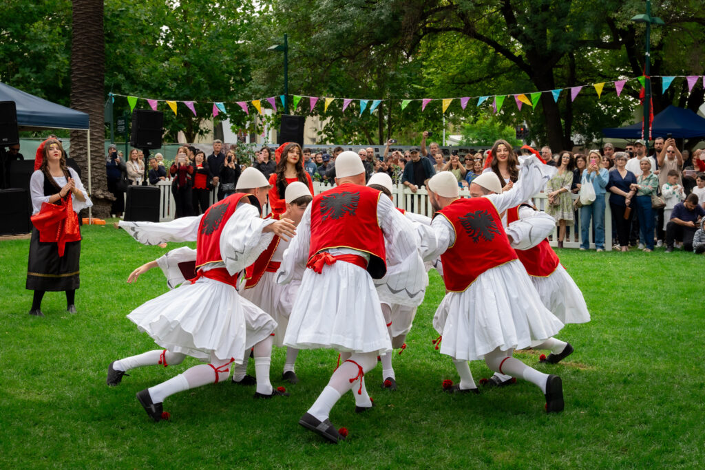 Albanian folk dancers in traditional costumes performing the valle dance at a cultural festival