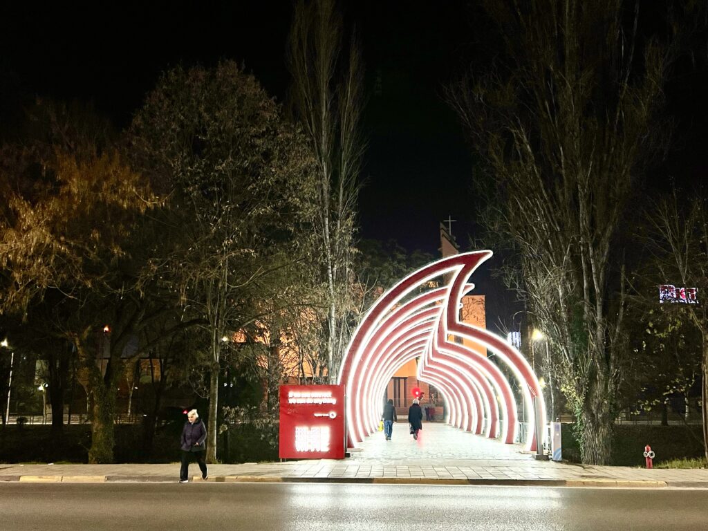 Beautifully illuminated pedestrian pathway in Tirana at night, reflecting the safe atmosphere of Albania's capital
