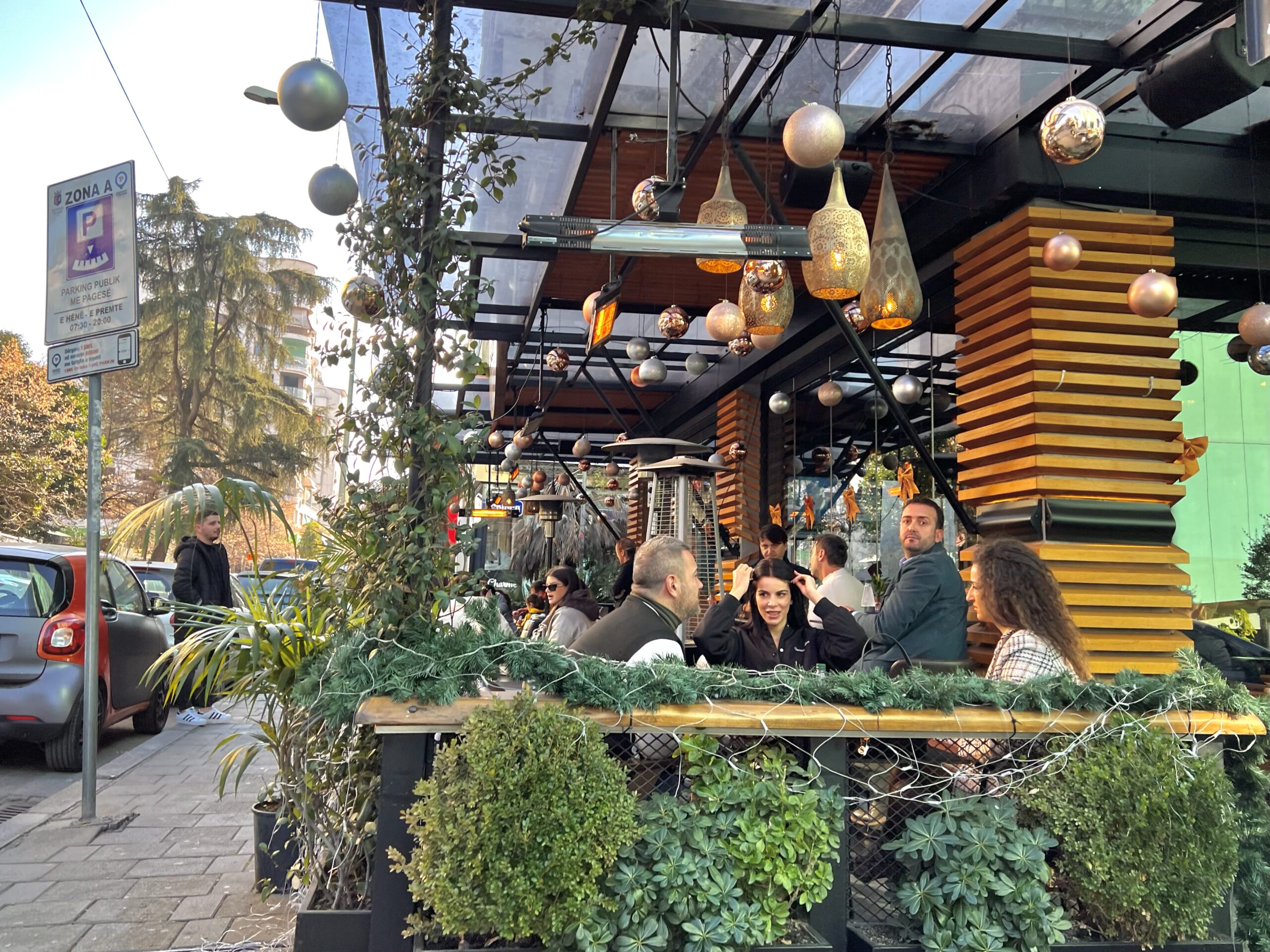 Outdoor cafe sidewalk seating in Tirana — coffee culture is central to daily life