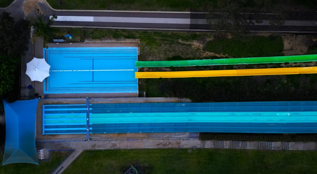 Aerial view of a water park with coloured slides and a pool (illustrative)