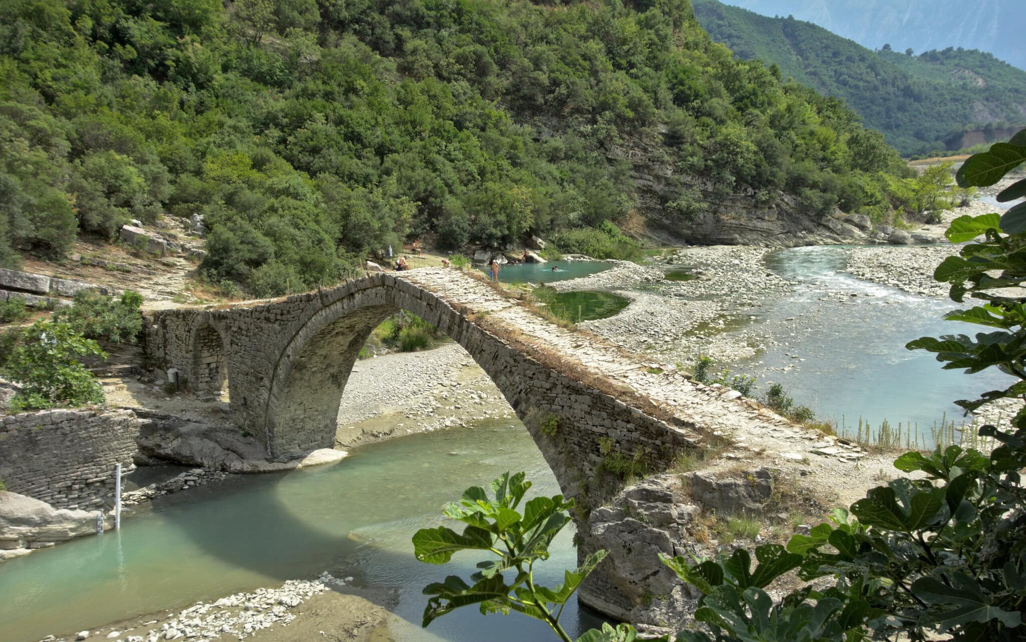 The thermal pools of Bënjë beside the Ottoman-era Katiu Bridge over the Lengarica river in southern Albania