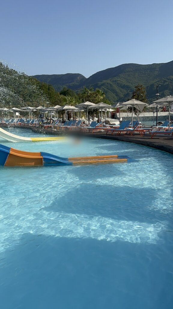 The kids slides and pool at Equos aquapark south of Tirana, with mountains behind