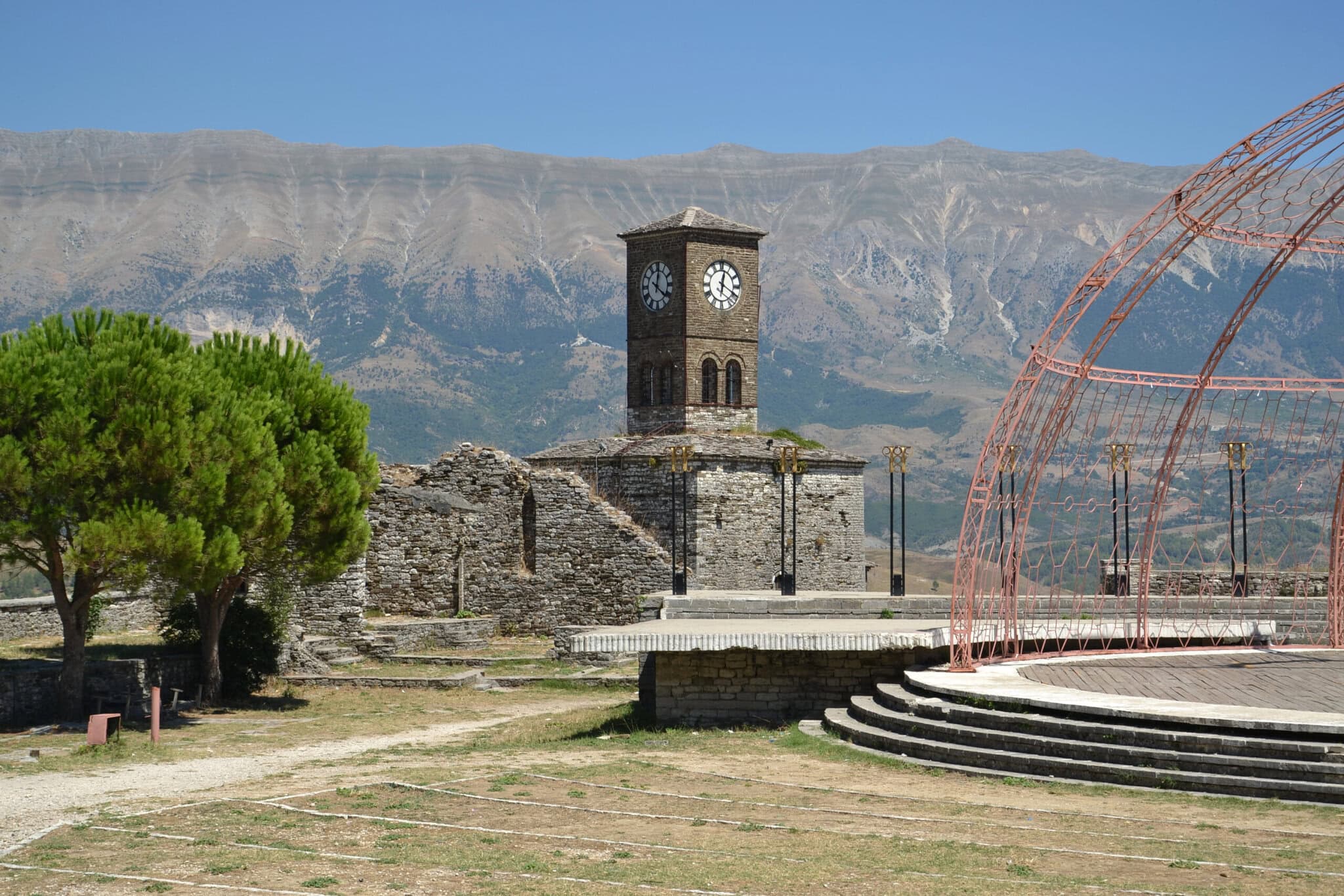 Gjirokastra Castle's stone clock tower rising above the fortress walls