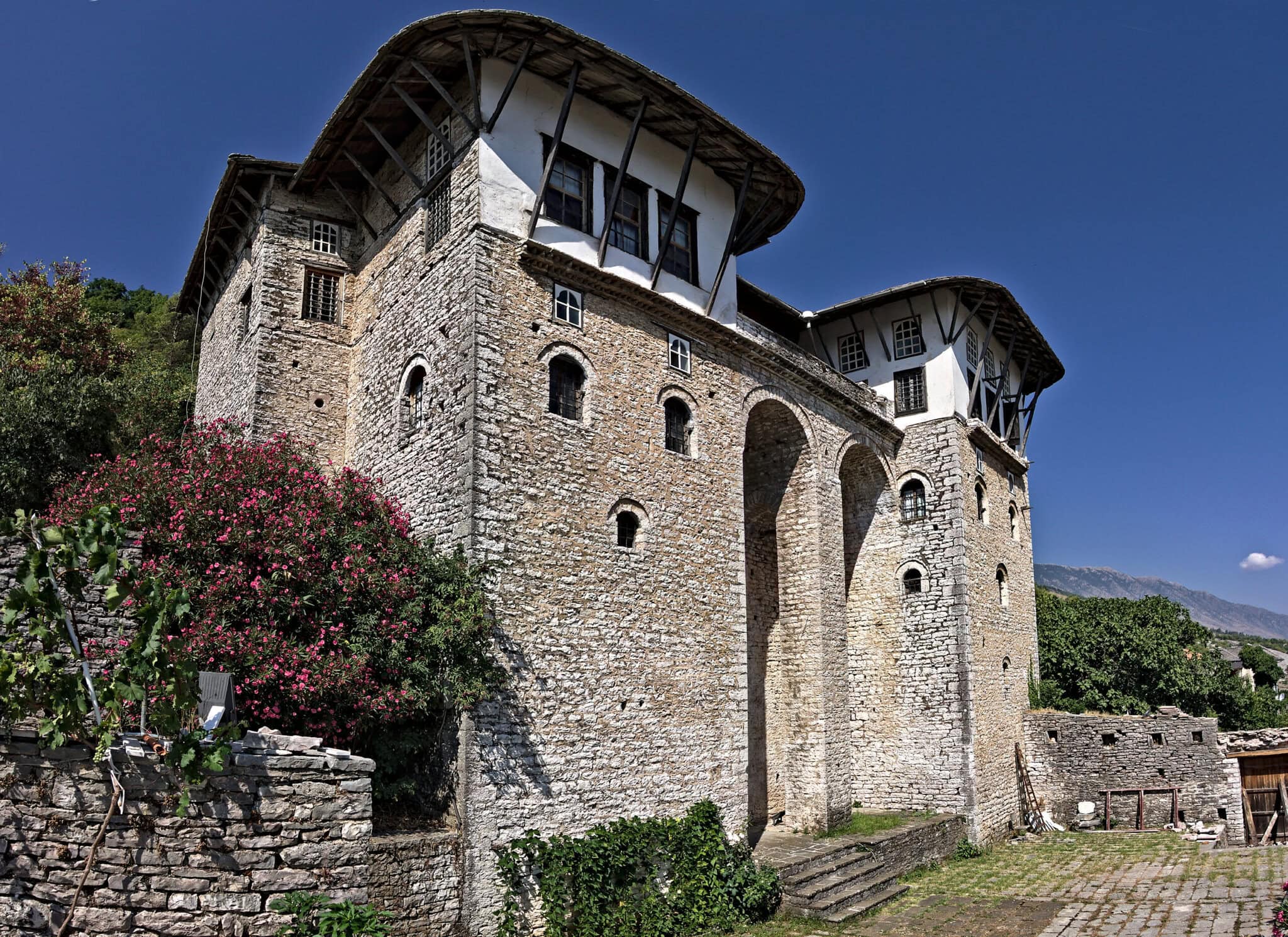 The twin-towered stone facade of the Zekate House, one of Gjirokastra's grandest Ottoman-era tower houses