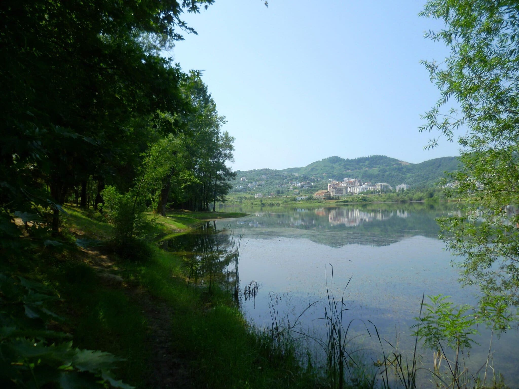 The Artificial Lake at the Grand Park of Tirana with the tree-lined promenade along its shore