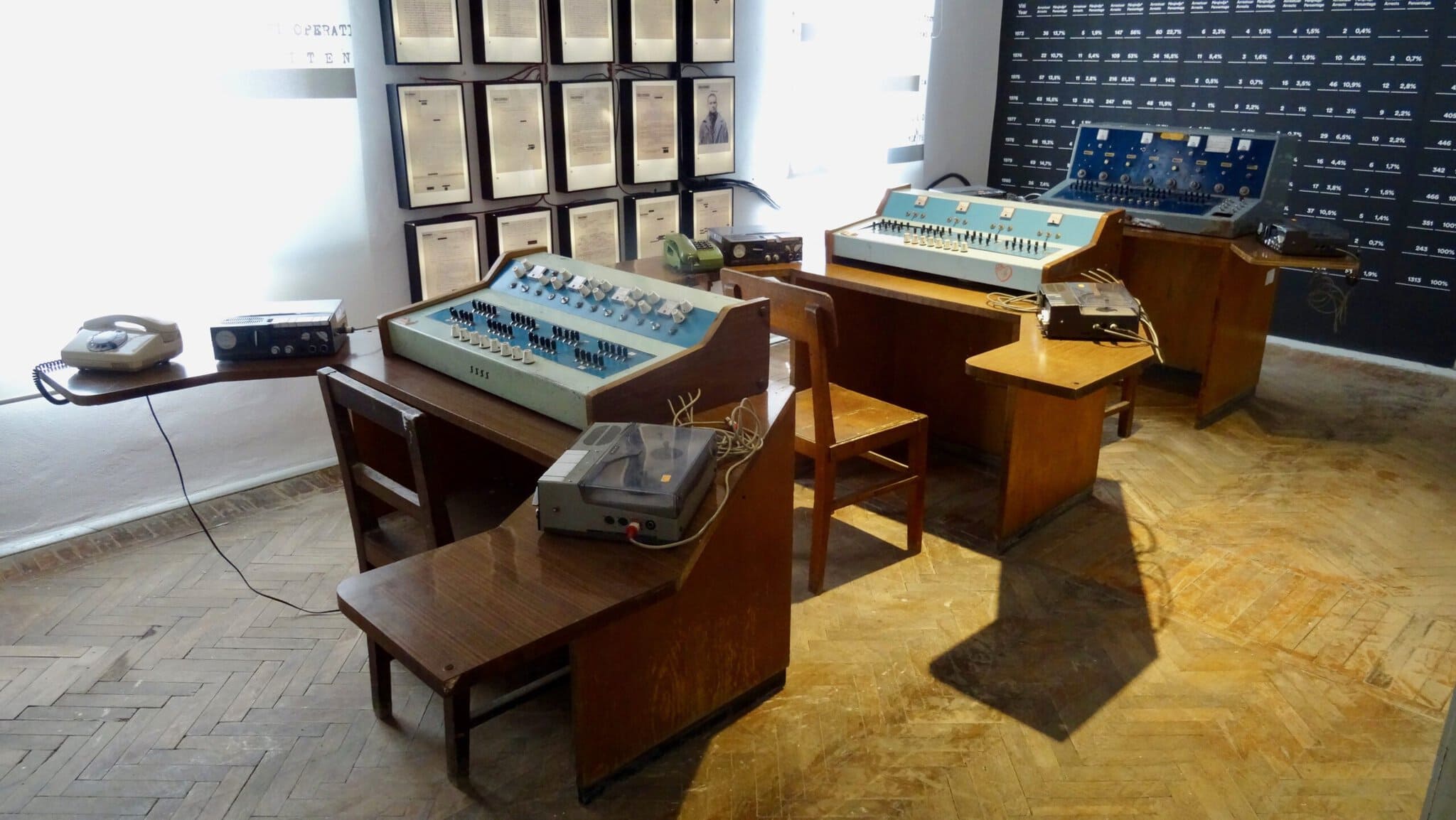Interior exhibition space inside the House of Leaves museum in Tirana showing surveillance-era displays