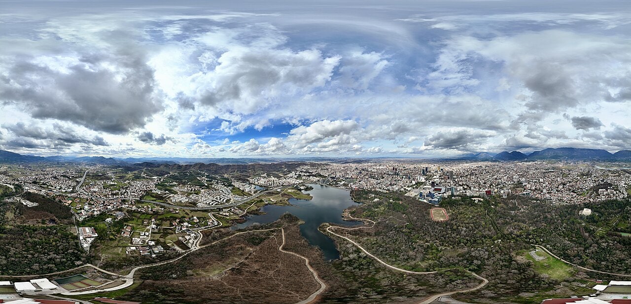 Liqeni Artificial, the Artificial Lake of Tirana, viewed across the water toward the park's shoreline trees