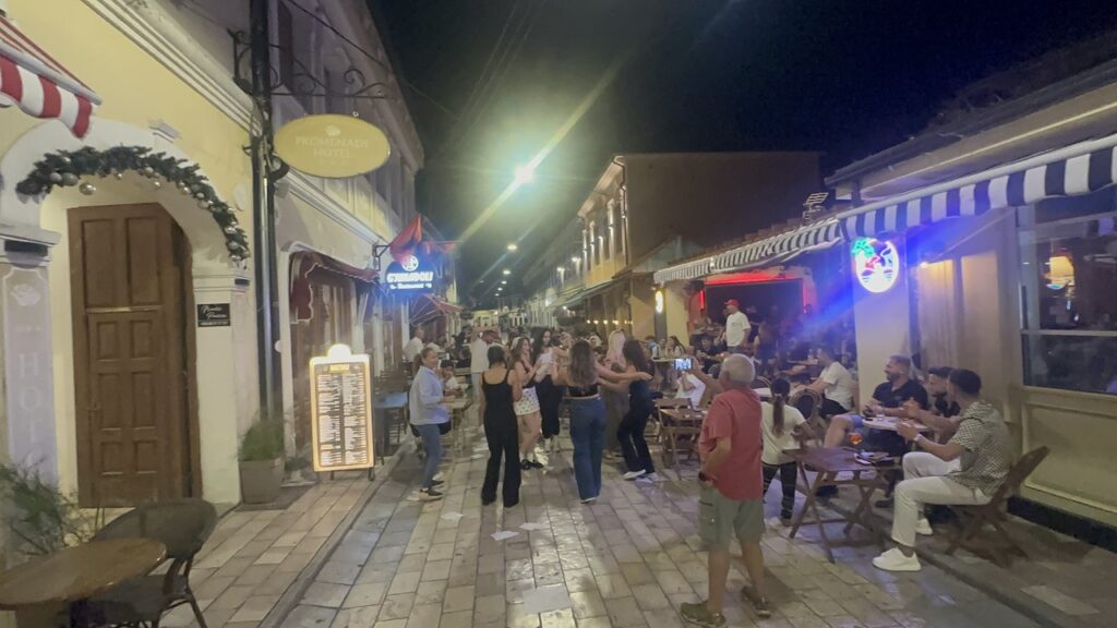 Crowds enjoying the Shkodra old bazaar after dark, with bars and restaurants open