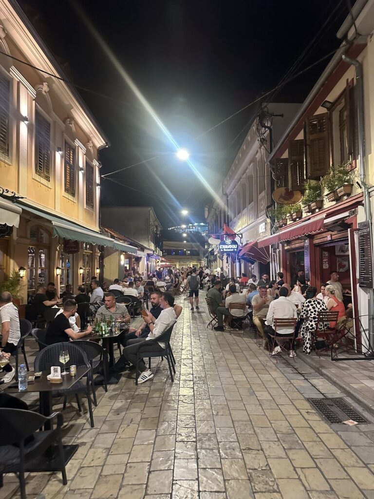 A lively pedestrian street in the Shkodra old bazaar at night