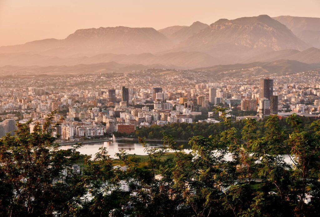 Aerial view of Tirana, Albania at golden hour, showing the city skyline and buildings